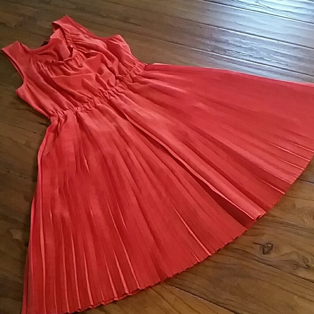 Pucker up for the bright orange dress.